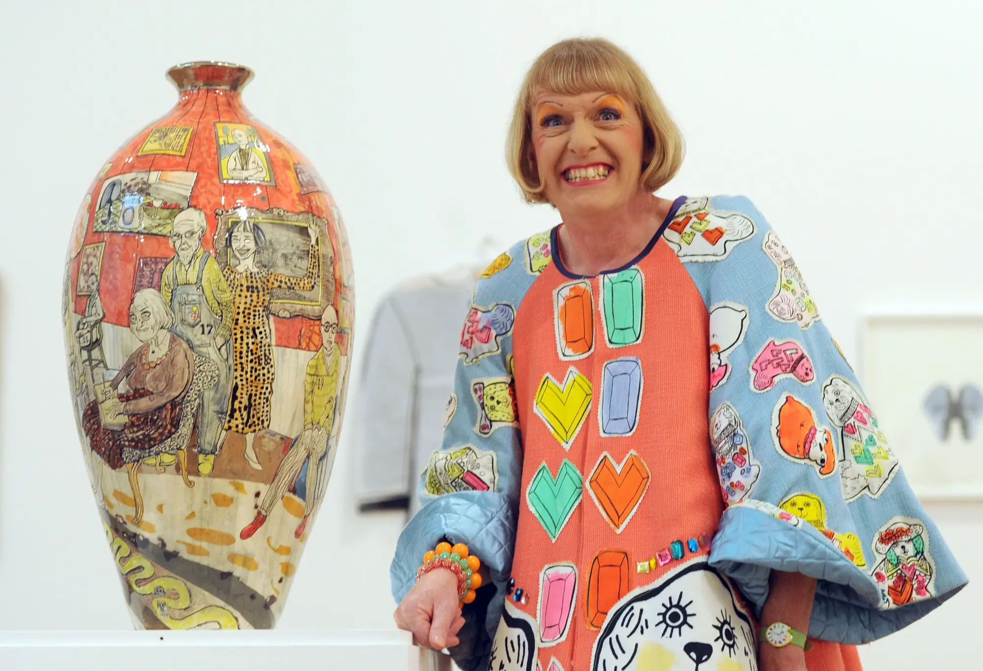 Grayson Perry as Claire, his female alter-ego, alongside one of his ceramic works.
