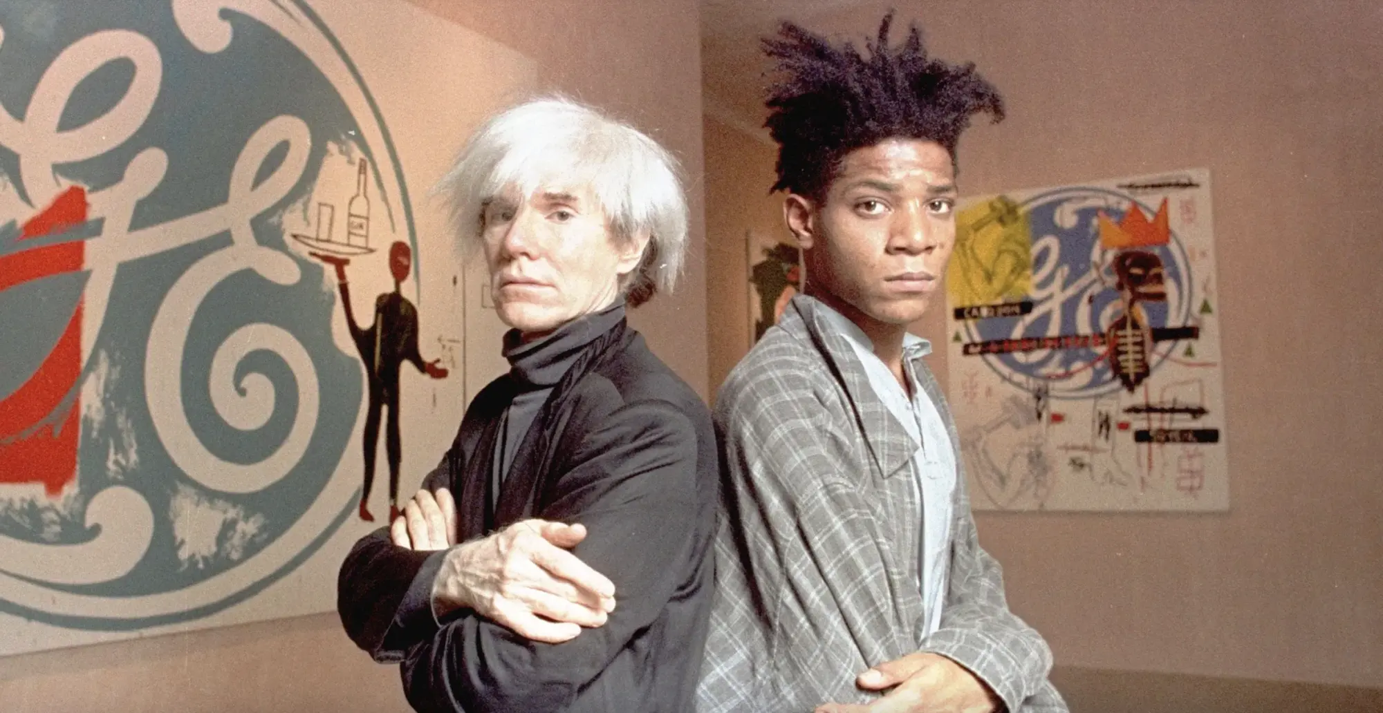 Jean-Michel Basquiat with Andy Warhol with works they created in collaboration, September 1985.