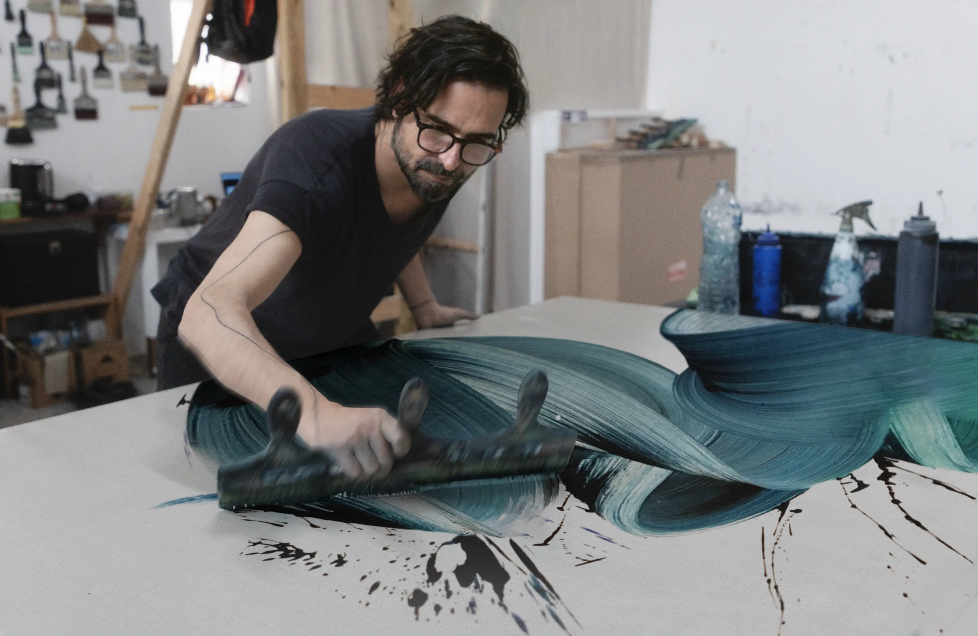 Kostas demonstrating his single brushstroke technique in the studio