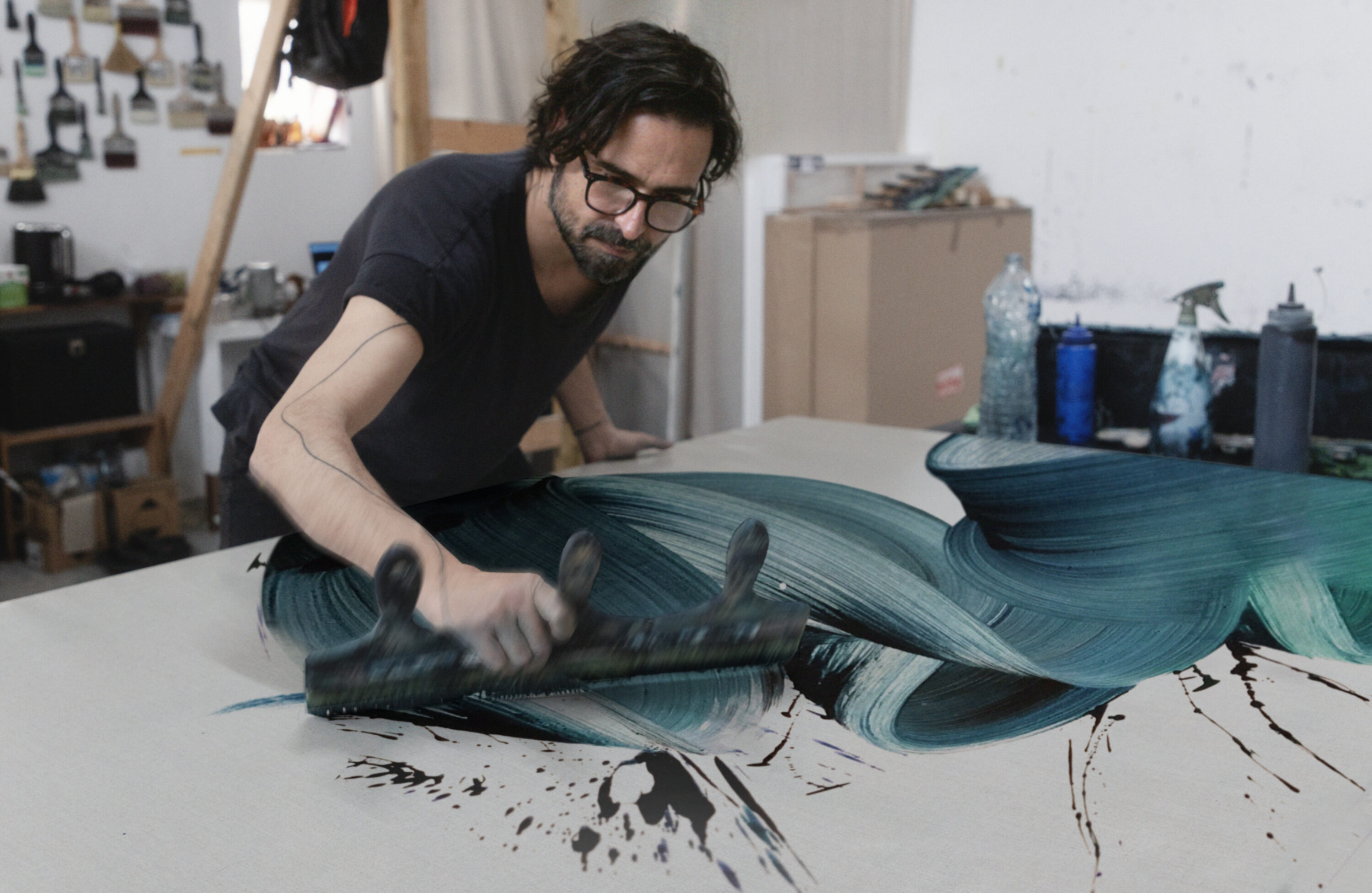 Kostas demonstrating his single brushstroke technique in the studio