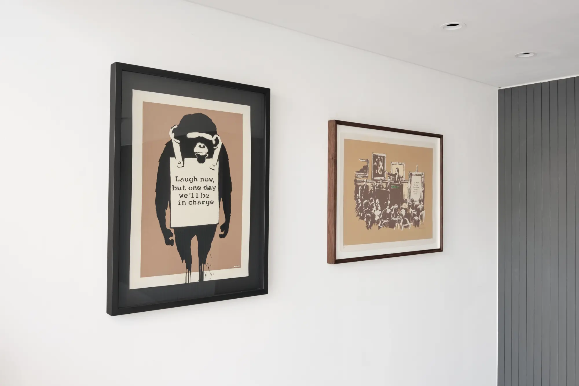 Banksy's Laugh Now and Morons (Sepia), both float mounted.