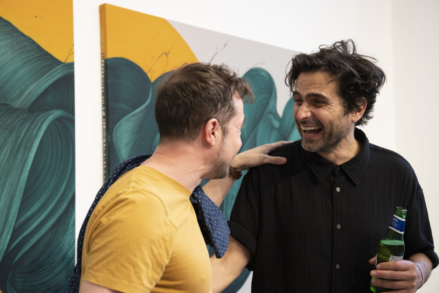 Guests connect and share laughs with Kostas during the lively private view