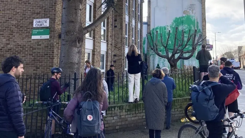 Crowds forming to see the new mural on Hornsey Road, north London.