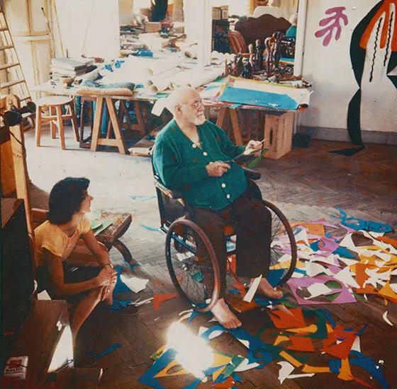 Henri Matisse working on the cutouts in his studio