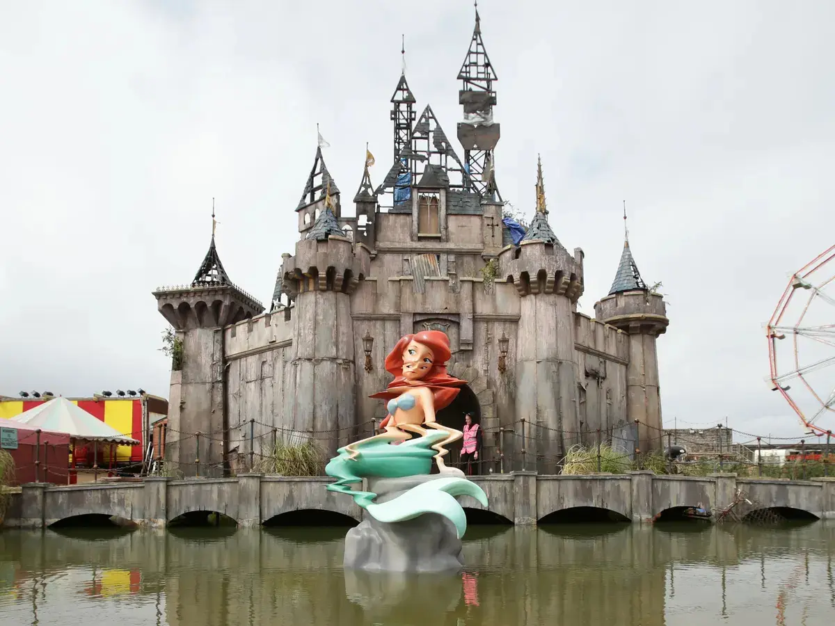 The staff around the park are in full Dismaland character looking miserable