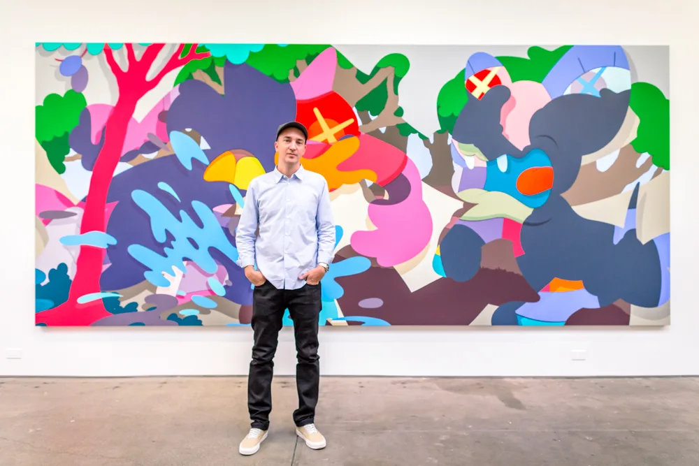 KAWS photographed with one of his originals