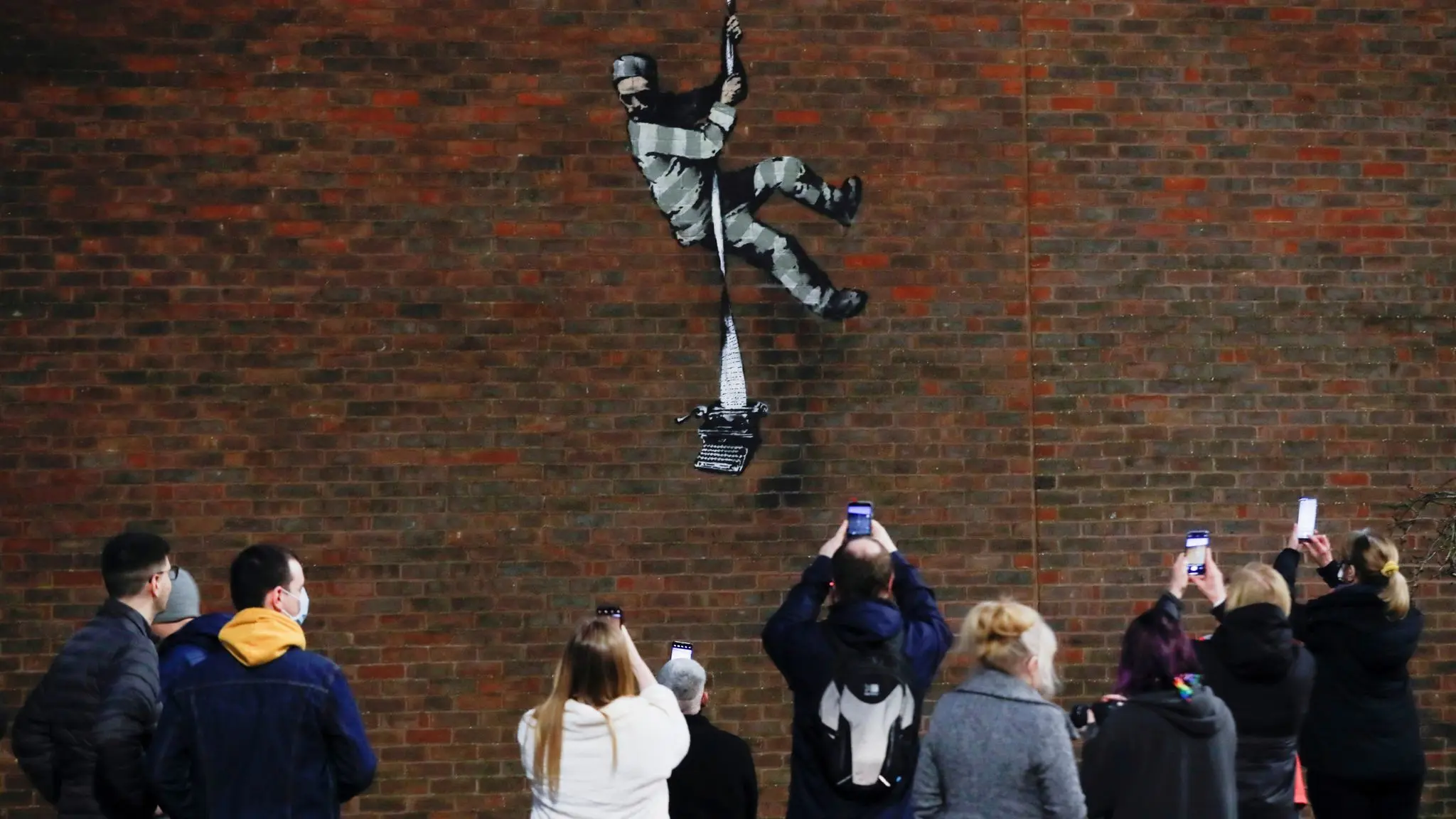 Crowds gathering outside the prison when the mural first appeared in March 2021