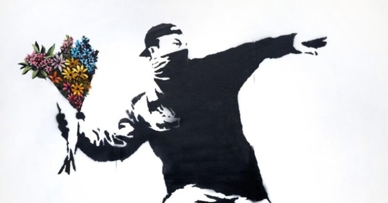A man throwing flowers in a street art piece
