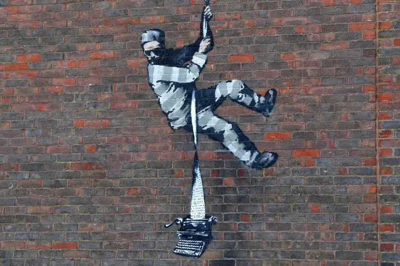 Banksy's latest street piece on the wall of an abandoned Reading Prison, March 2021.