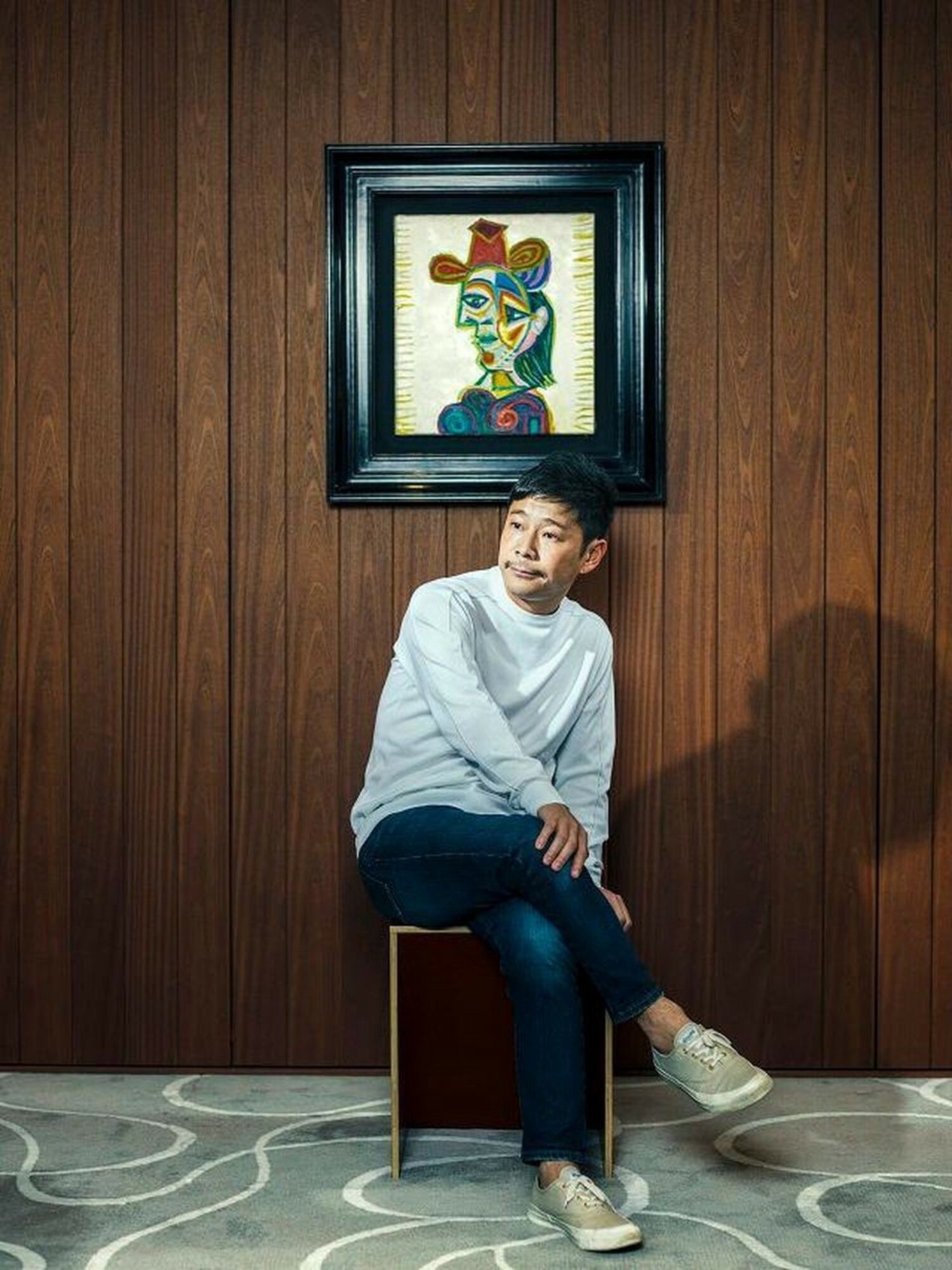 Yusaku Maezawa with his Picasso painting, "Buste de Femme (Dora Maar)".