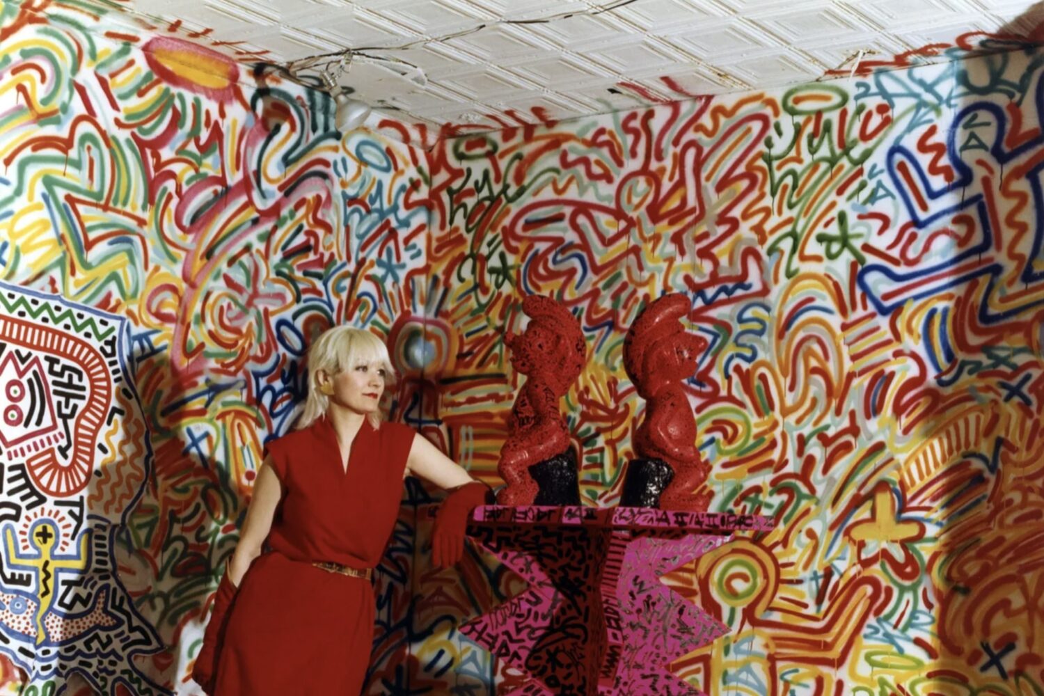 Patti Astor with Keith Haring and LA 2’s 'The Smurfs' at the FUN Gallery in February 1983. Photo by Eric Kroll