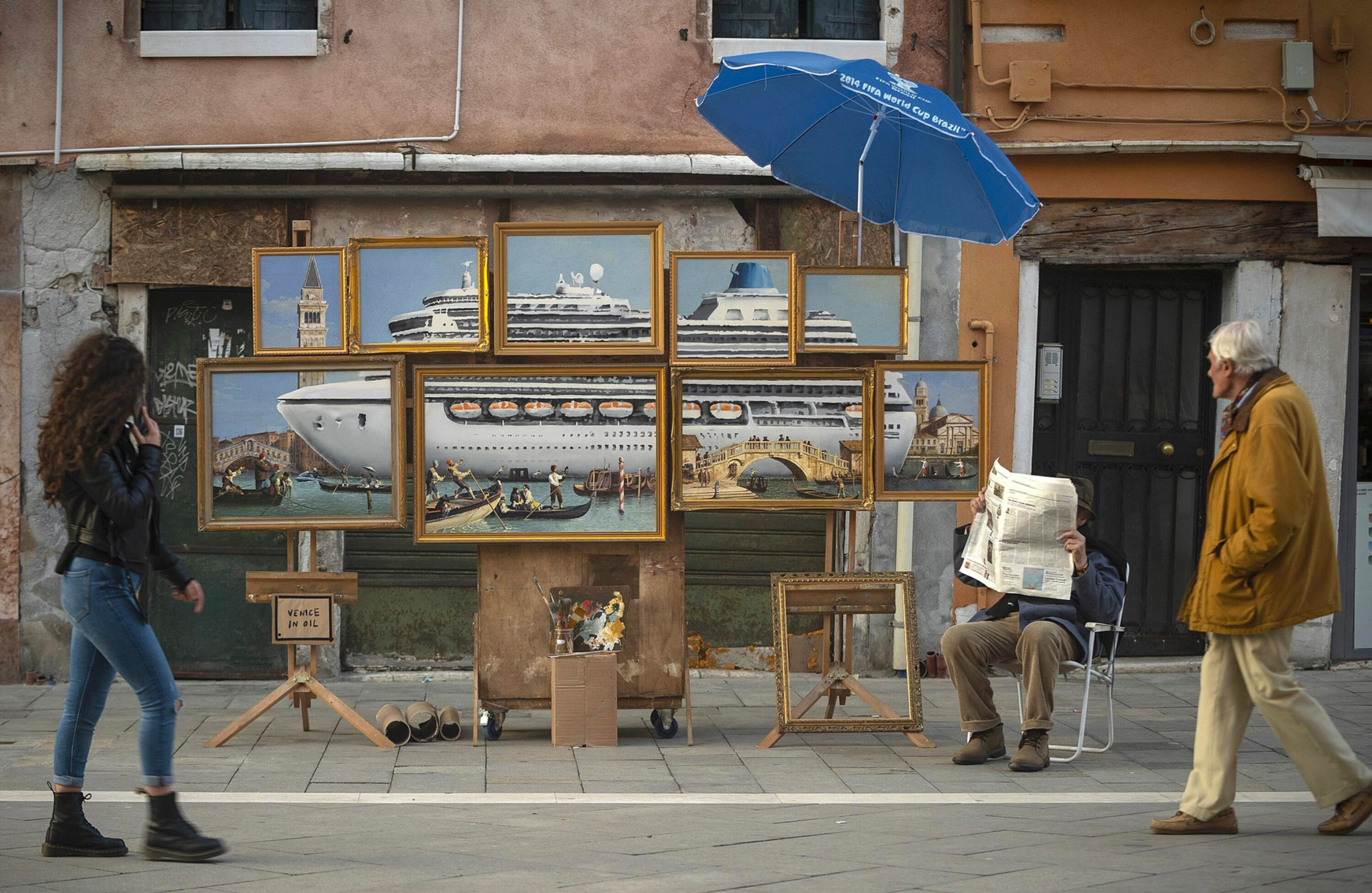 Banksy takes an unconventional approach to exhibiting artwork at the Venice Biennale setting up a street stall