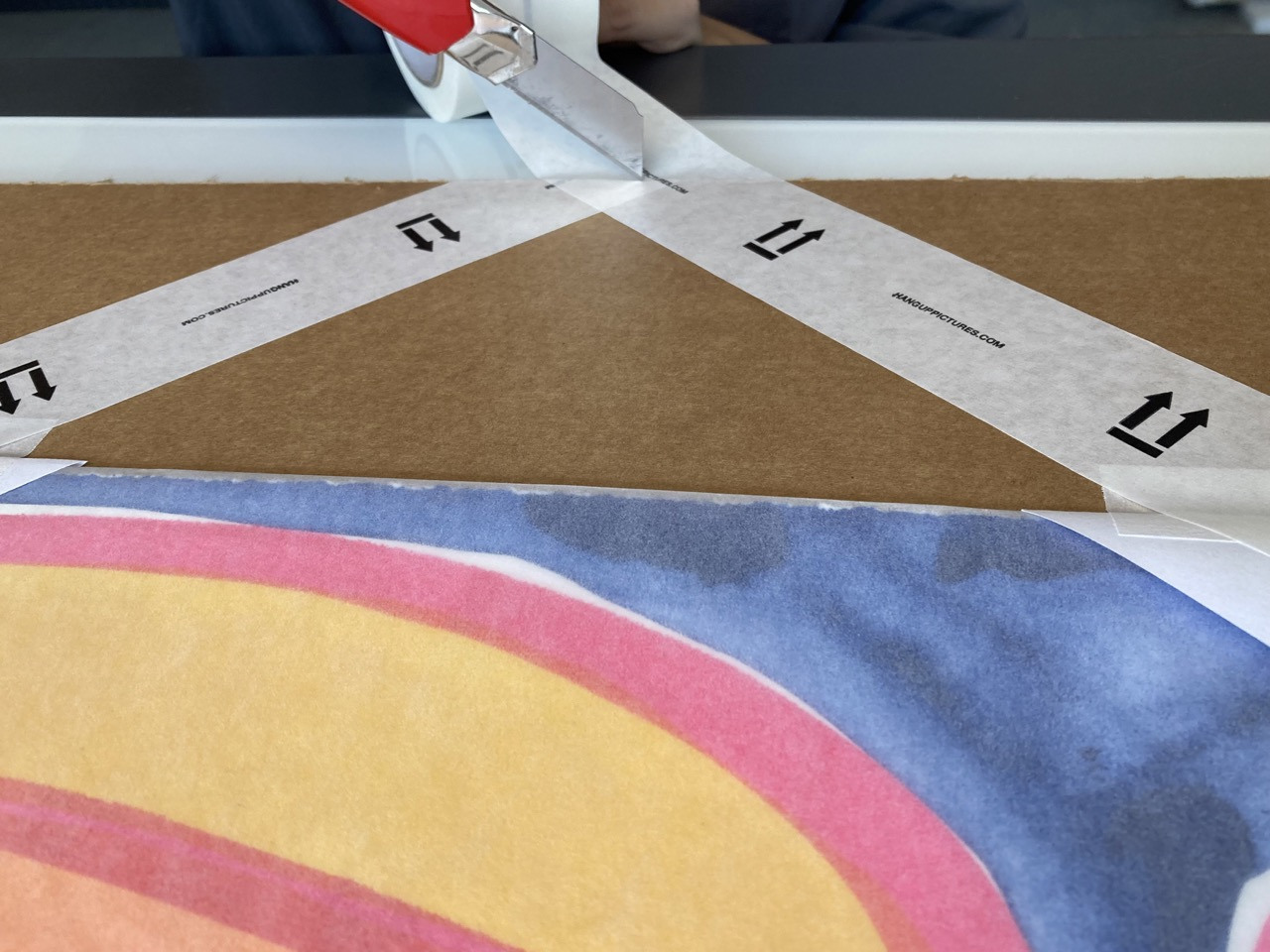 6. Secure the corners by taping down across diagonally and then along the edges using masking tape.